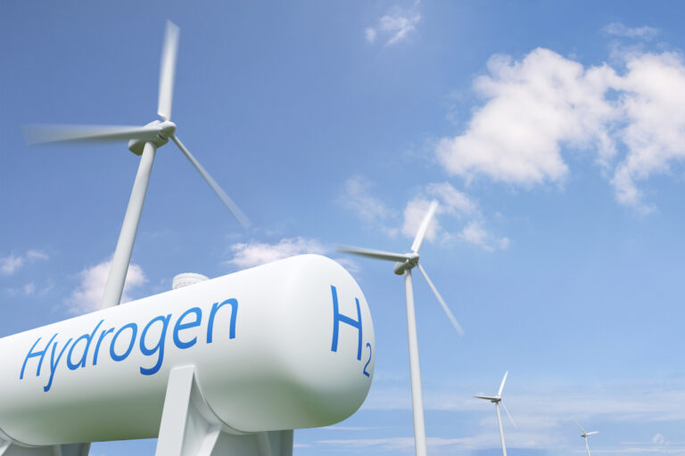 3D illustration. Hydrogen tank and windmills on blue sky background.