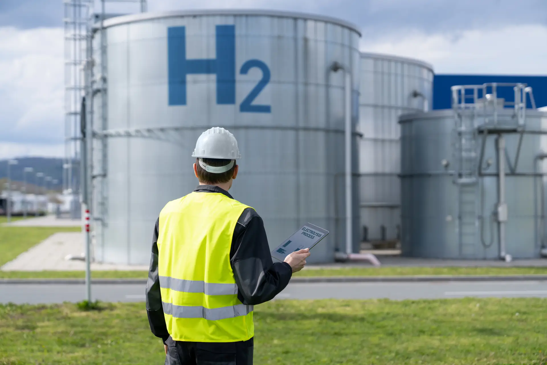 Engineer with tablet computer on a background of Hydrogen factory